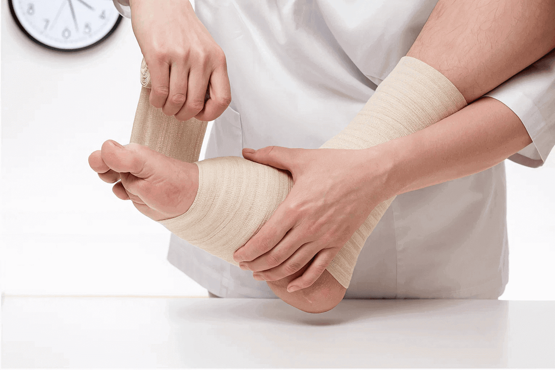 Close-up of doctor bandaging foot of patient
