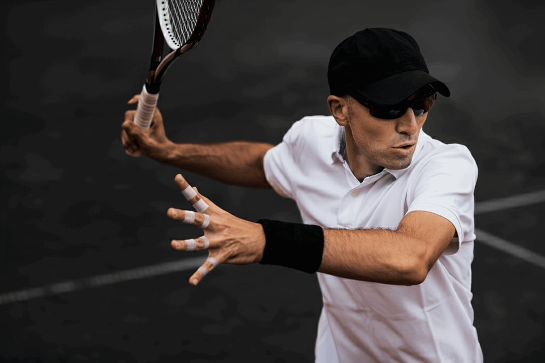 tennis player hitting forehand with fingers taped for support