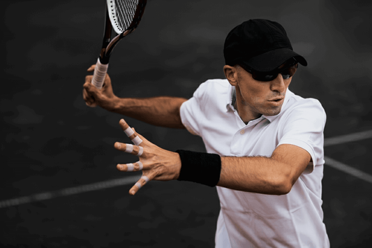 tennis player hitting forehand with fingers taped for support