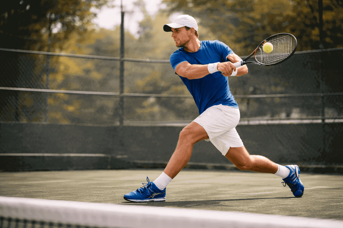 A man playing tennis on an outdoor court